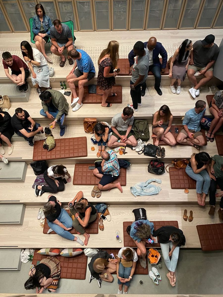 Overhead view of a crowd sitting together on wooden steps